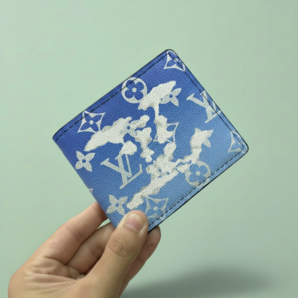 Blue monogram cloud pattern wallet held in hand on light pastel mint green background