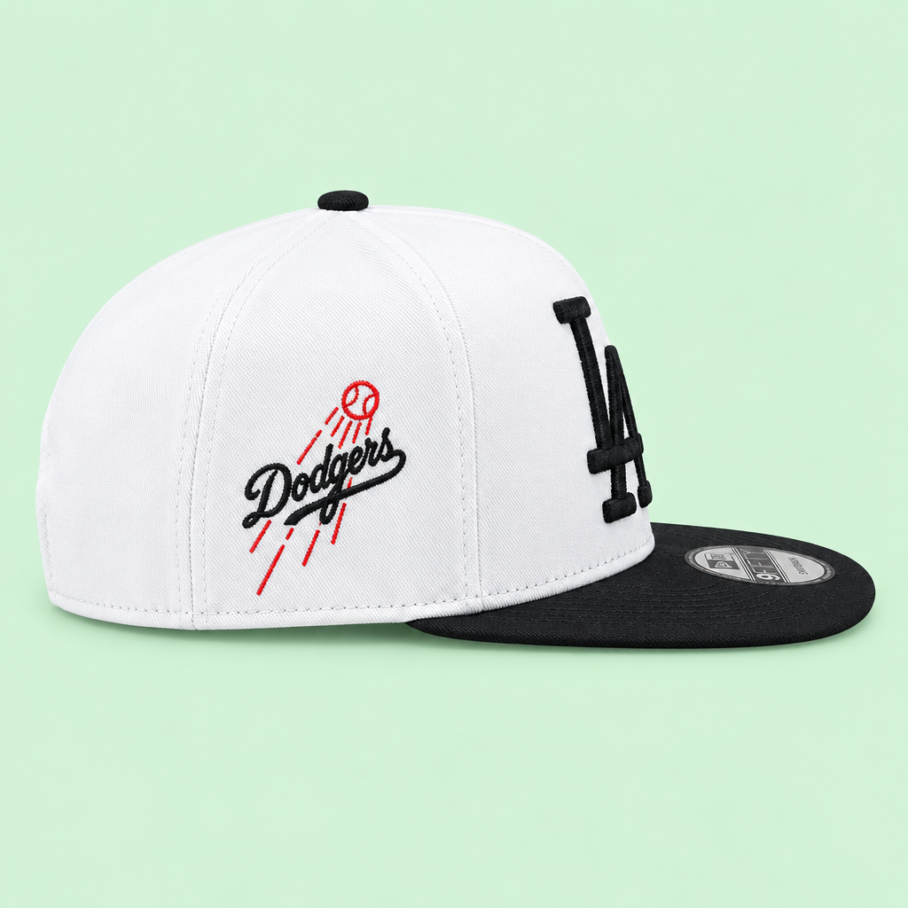 White and black embroidered snapback cap, left-side profile on pastel mint background