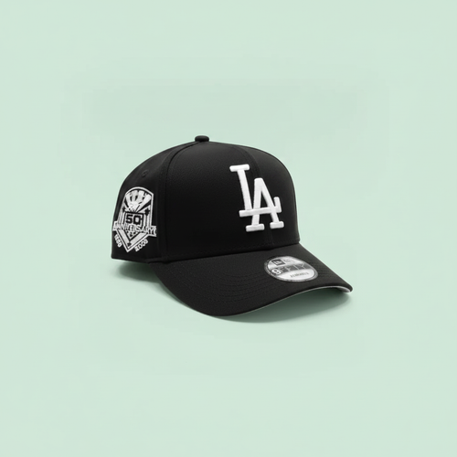 Black embroidered baseball cap left side view on a pastel mint green background