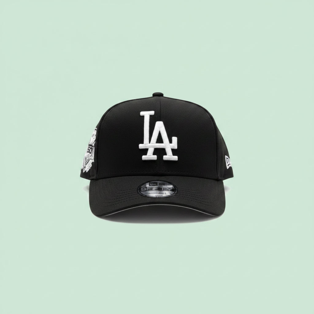 Black embroidered baseball cap front view on a pastel mint green background