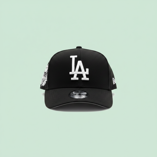 Black embroidered baseball cap front view on a pastel mint green background