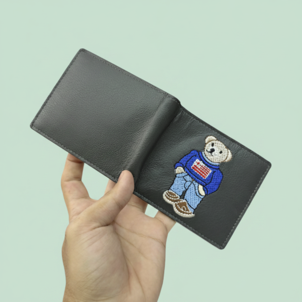 Hand holding teddy bear wallet front view