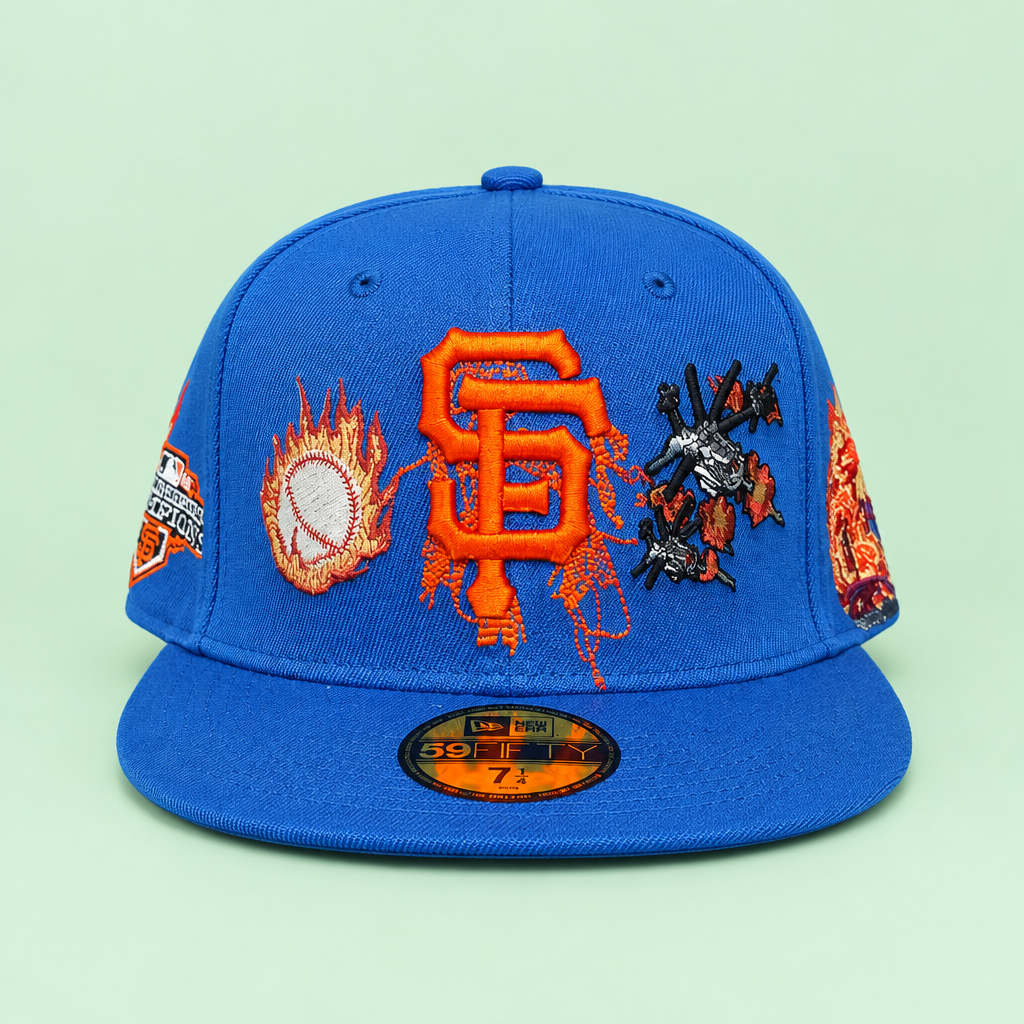 Blue flat-brim cap with orange embroidery on pastel mint green background