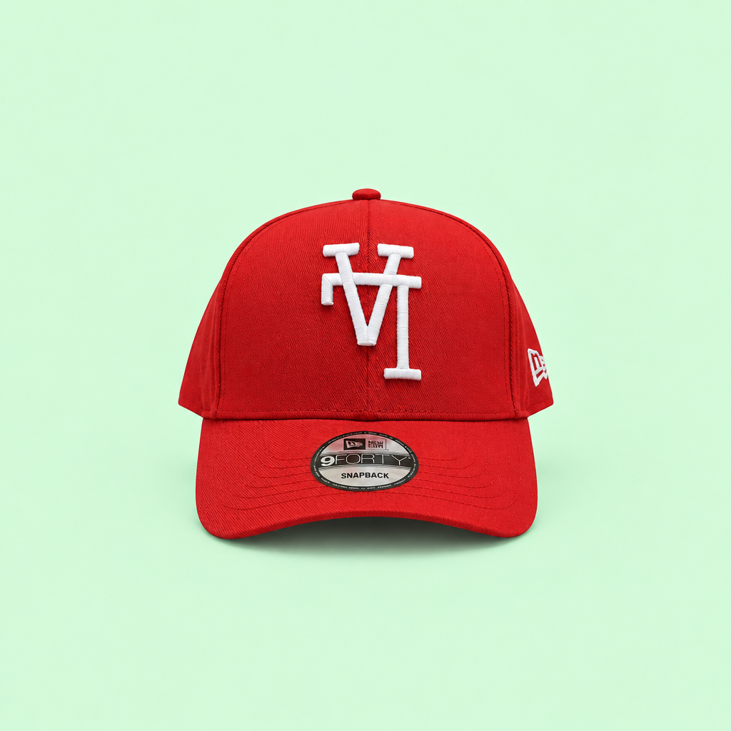 Red cap with white raised embroidery, long-range front view on pastel mint background