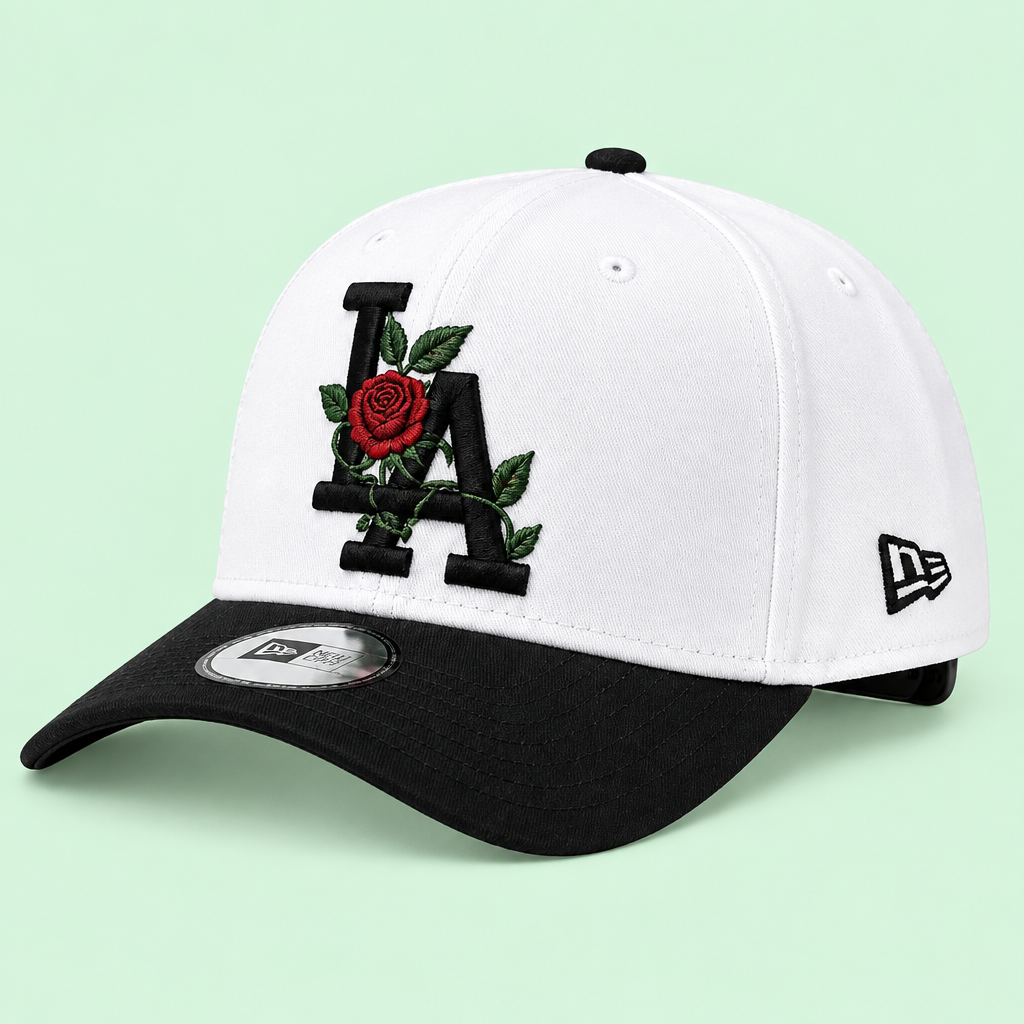 White cap with black brim and rose embroidery, left three-quarter angle