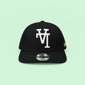 Black snapback cap with white raised embroidery, long-range front view on mint background