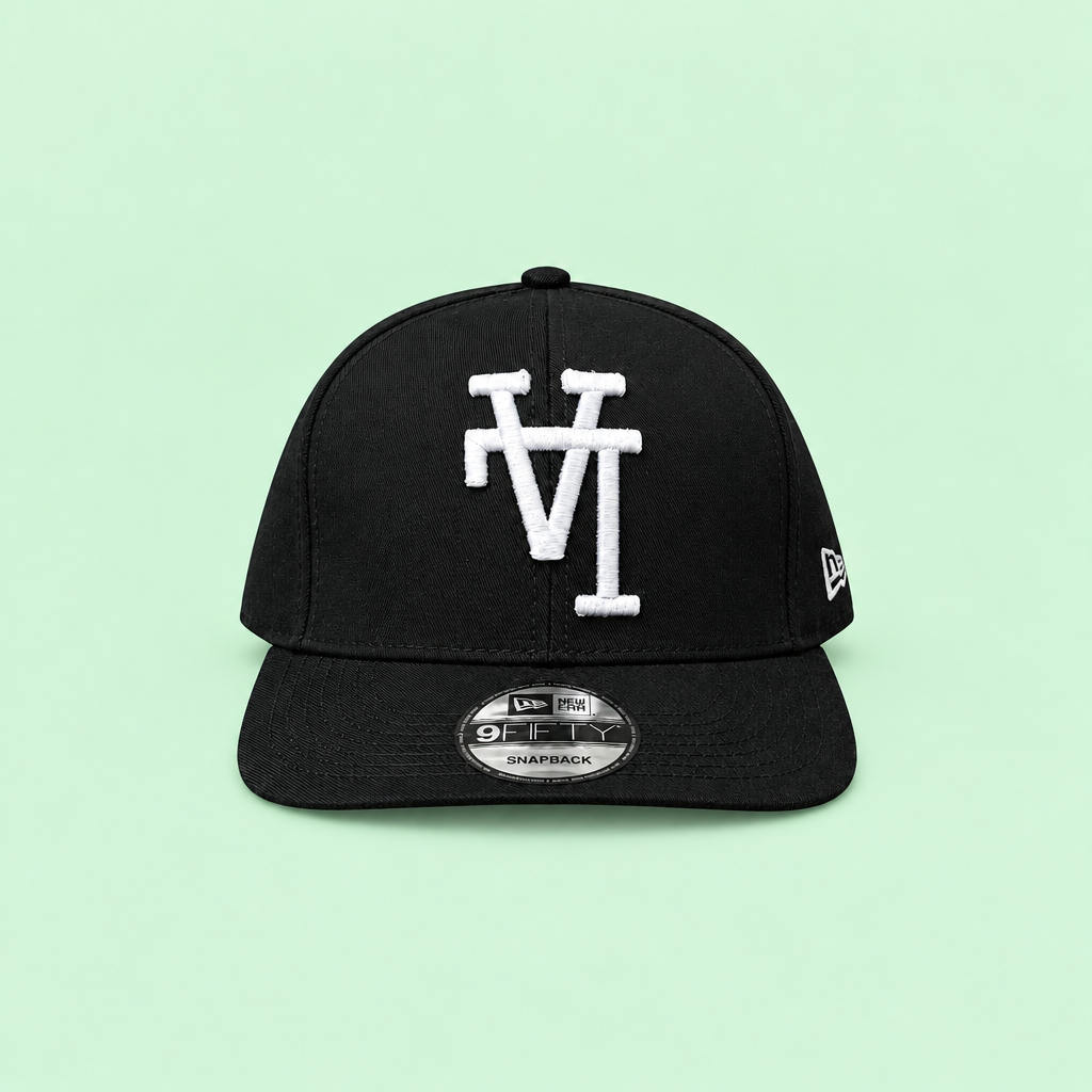 Black snapback cap with white raised embroidery, long-range front view on mint background