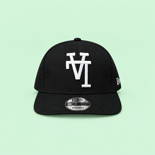 Black snapback cap with white raised embroidery, long-range front view on mint background