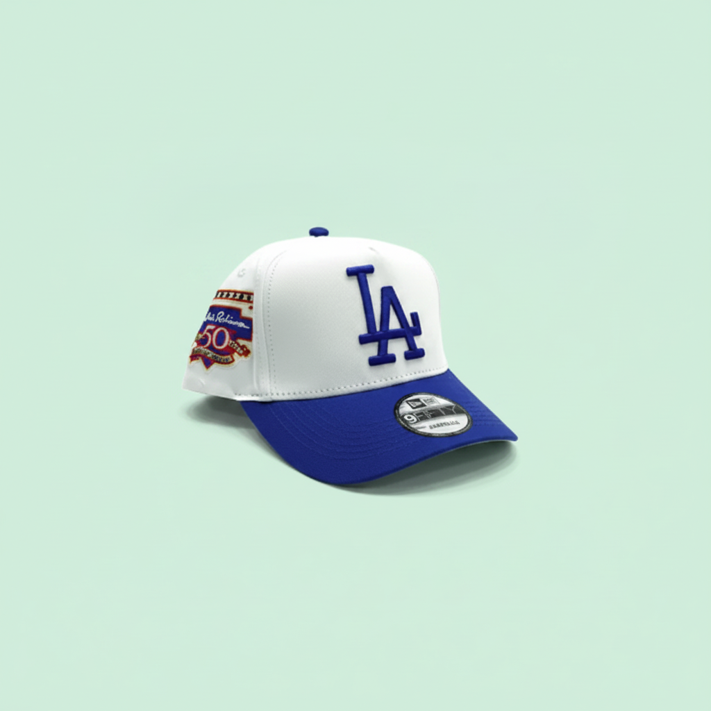 White and blue embroidered baseball cap right front three-quarter view on a pastel mint green background