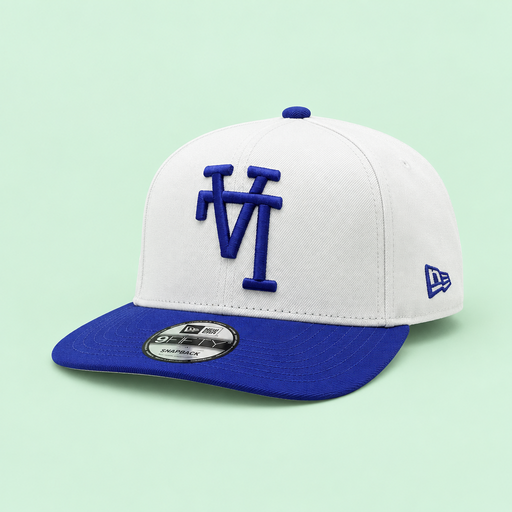 White cap with blue brim, right three-quarter angle on pastel mint background