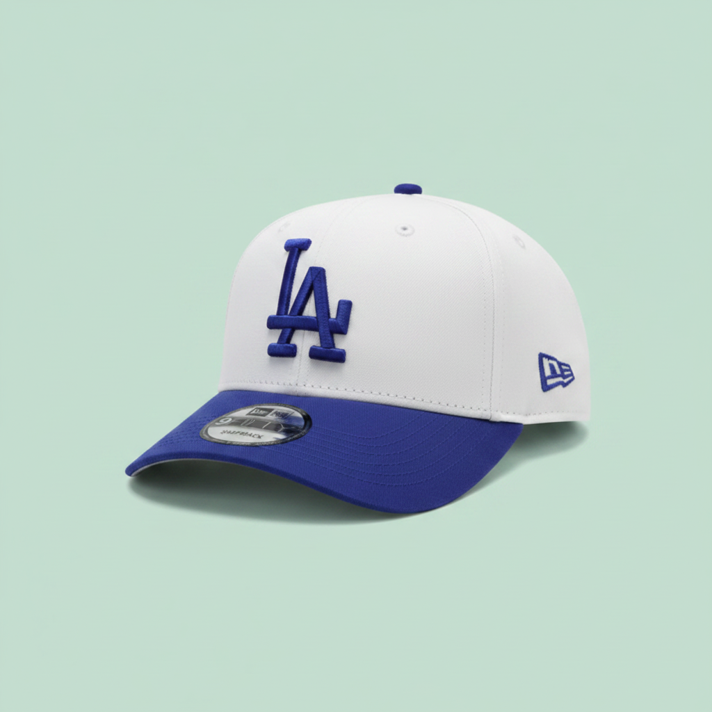White and blue embroidered cap left front three-quarter view on a pastel mint green background